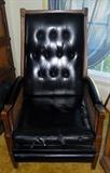 Large chair with black leather seat
