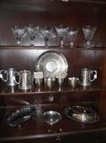 Top shelf has 6 Waterford stems and middle shelf has pewter Jefferson cups and mugs