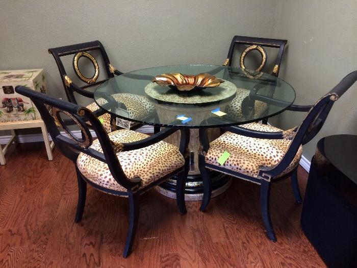 Wonderful glass top dining table with four leopardprint chairs