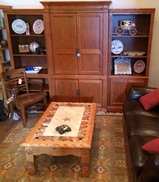Oak media center with bookcases, Mexican rug, pine and tile coffee table.