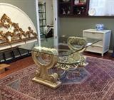 Glass topped dining table, wrought iron and glass white coffee table, large wool rug, white kingsize rattan headboard and nightstand, and gold kingsize metal headboard.