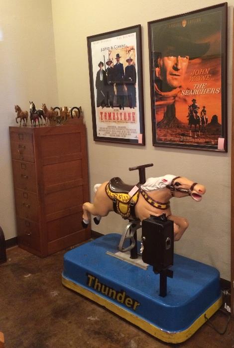 Vintage oak file cabinet, framed movie posters, and THUNDER -- a vintage mechanical horse in great working condition.