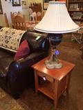 Maitland Smith lamps (one of two), Italian leather sofa, and oak nightstands (one of two).