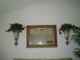 Mirror in living room with pair of sconces