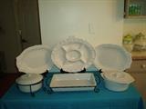 White ceramic bakers with holders and ceramic platters.  
