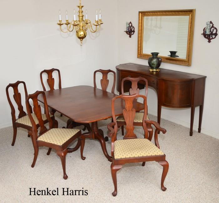 Lot 1090:  HENKEL-HARRIS WILD BLACK CHERRY DINING TABLE AND 6 CHAIRS: With multiple tags under table top, made of solid wild black cherry wood. Table with double pedestal base, splayed legs. Sold with 6 matching chairs with floral upholstery (arm chair, 39'' h. x 24 1/2'' x 24'').
CONDITION: Table top with scuffs, other wear consistent with everyday use.