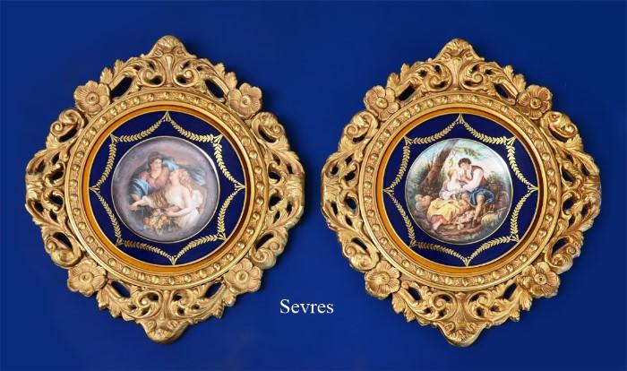 Lot 1113:  SIGNED FRAMED PORTRAIT PLATE: Sevres style, embellished transfer scene of lover, signed Donato, cobalt rim with gilt garland decoration, 9 5/8'' dia. Framed in carved gilt wood frame, 19'' x 17''.
CONDITION: Paper backing has been glued to back of plate, possible Sevres mark on back.      Lot 1114:  SIGNED FRAMED PORTRAIT PLATE: Sevres style, embellished transfer scene of 2 maidens, one with cornucopia and sheaf of wheat, signed Donato, cobalt rim with gilt garland decoration, 9 5/8'' dia. Framed in carved gilt wood frame, 19'' x 17''.
CONDITION: Paper backing has been glued to back of plate, unable to ascertain any markings.