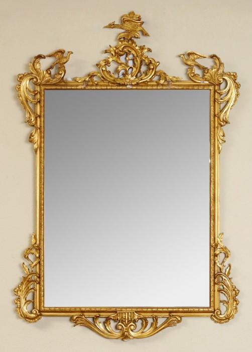 Lot 1059:  CHINESE CHIPPENDALE STYLE GILT WOOD MIRROR: Carved gilt wood frame with figural birds and foliate scroll motifs, 60'' h. x 40 1/4'' x 2''.
CONDITION: Loss of gilt and decoration.