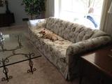 Off-white sofa with blue, gray, beige floral design (Gaylord blue).  It was made by the Lincoln Furniture Mfg. Co.  Dog is not available!
