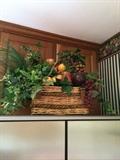 A basket full of silk greenery and fruit. A wonderful addition to your kitchen.