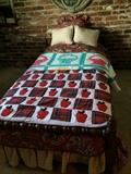 Two handmade quilts on child's bed