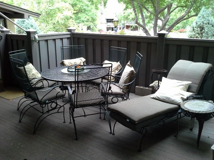 Patio furniture, 6 bouncy chairs, round table, chaise, cushions, pillows, antique iron side table.