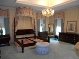 Master Bedroom-First Floor:  An overview of this elegant room with the ivory moire fabric walls and window treatments, including the bed canopy.