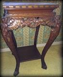 Gorgeous antique wooden table with ornate wood carving and paw feet!