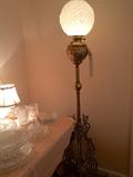 Ornate brass floor lamp with stunning angel-face shade