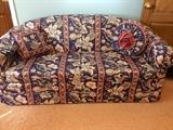 Upholstered sofa with pillows