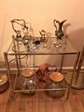 Ornamental brass decor items and faux-bamboo leg/glass-top accent table