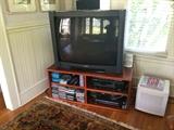 Cherry TV stand and large subwoofer.