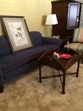 Blue sofa; 1 of 2 monkey pictures; butler's tray table; 1 of 2 striped chairs; TV armoire