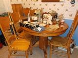 Center pedestal oak table w/leaf and six pressed back chairs