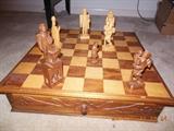 ONe of greatest chess set with its inlaid top , carved sides and carved pieces.