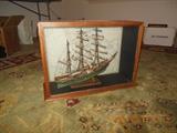 A framed model sailing ship