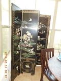 This is a beautiful Chinese 4 panel room divider.  Made of very heavy wood that has been painted in a black lacquer.Extremely detailed soapstone carvings adorn each panel. Around each panel is inlaid mother of pearl.