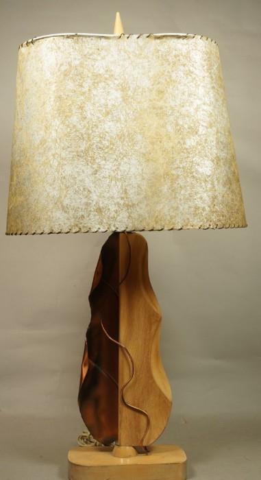 Lot 6  -  HEIFETZ Wood & Copper Leaf Table Lamp. Carved wood and copper sculptural leaf form. Original shade. Signed.-- Dimensions:  H: 35 inches: W: 9 inches: D: 5.5 inches --- 