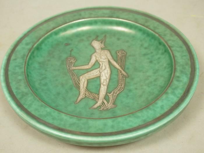 Lot 24  -  GUSTAVSBERG Sweden Argenta Plate. Silver Design of female nude floating amongst sea plants. Green glaze on five feet. Marked. Paper label. -- Dimensions:  H: 1.5 inches: W: 9 inches: D: 9 inches --- 