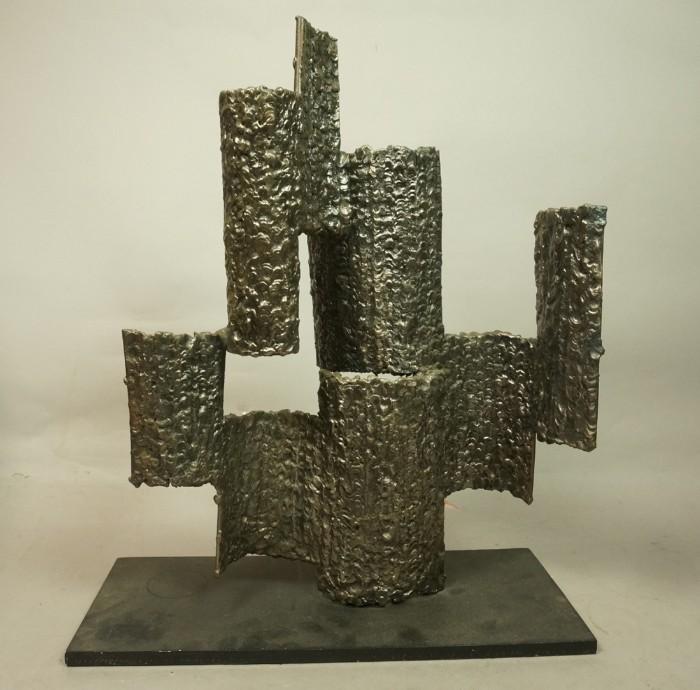 Lot 61  -  Brutalist Metal Sculpture. J. STEWER?. Textured metal stacking panels. Signed. -- Dimensions:  H: 21 inches: W: 17.25 inches: D: 7.25 inches --- 
