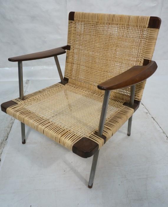 Lot 71  -  Finn Juhl Style Rosewood and Steel Lounge Chair  Large Shaped arms. Steel legs capped with wood that cuts up into leg. Cane seat and back.-- Dimensions:  H: 32.5 inches: W: 30 inches: D: 26 inches --- 