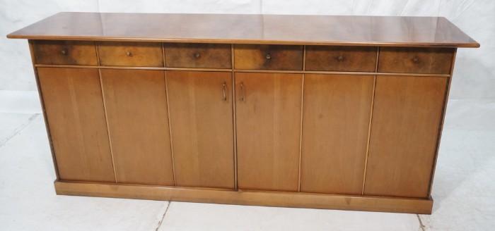 Lot 78  -  Milo Baughman for Directional Sideboard Credenza.  6 drawers over trifold doors.  Figured wood.  Nicely fitted interior.-- Dimensions:  H: 34.5 inches: W: 80 inches: D: 20.25 inches --- 