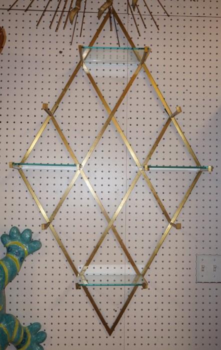 Lot 79  -  Modernist Diamond Frame Wall Shell. Brass finish with glass shelves.-- Dimensions:  H: 46 inches: W: 17.25 inches: D: 6.25 inches --- 