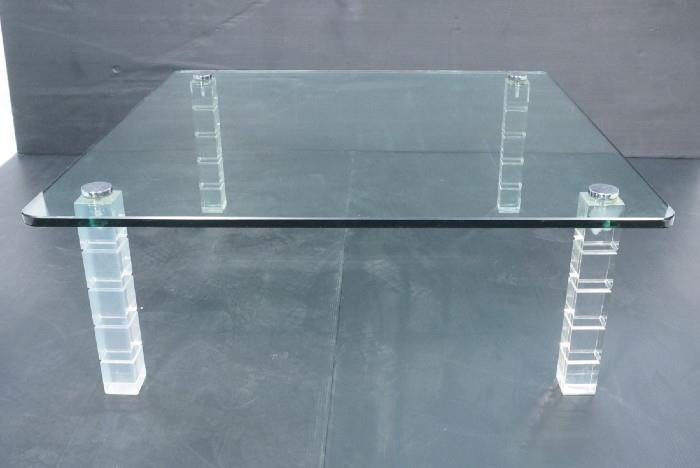 Lot 90  -  Modernist Lucite and Glass Coffee Cocktail Table.  3/4 "  thick glass on acrylic legs having chrome caps.-- Dimensions:  H: 16 inches: W: 42 inches --- 