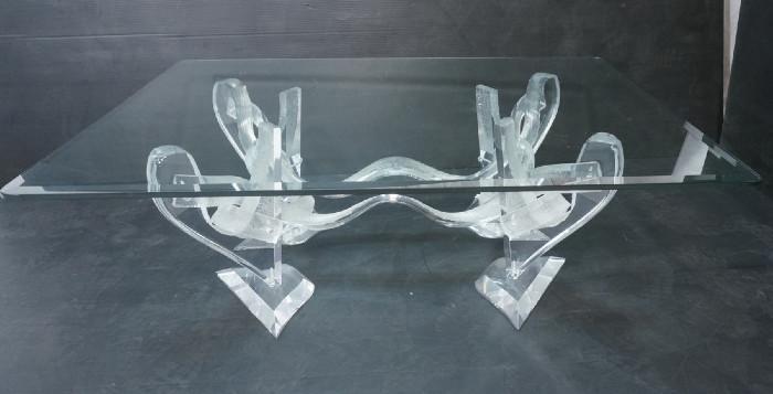 Lot 100  -  70's Modernist Lucite and Glass Coffee Cocktail Table.  Twisted acrylic frame with textured design.  Thick beveled glass top.-- Dimensions:  H: 15.25 inches: W: 48 inches: D: 36 inches --- 