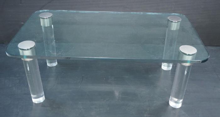 Lot 123  -  Baughman Style Coffee Cocktail Table.  3/4" thick glass top on Lucite acrylic column legs.  Silver caps.-- Dimensions:  H: 15.75 inches: W: 42 inches: D: 24 inches --- 