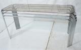 Lot 124  -  Baughman Style Chrome and Glass Console Table.  Inset smoked glass.-- Dimensions:  H: 26.5 inches: W: 53.25 inches: D: 18.75 inches --- 