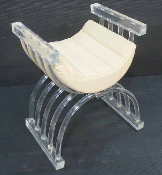 Lot 121  -  Acrylic Lucite Vanity Bench with Cream leather cushion.  Gondola form.  Arched base.  Chrome accents.-- Dimensions:  H: 27.25 inches: W: 25 inches: D: 17.25 inches --- 