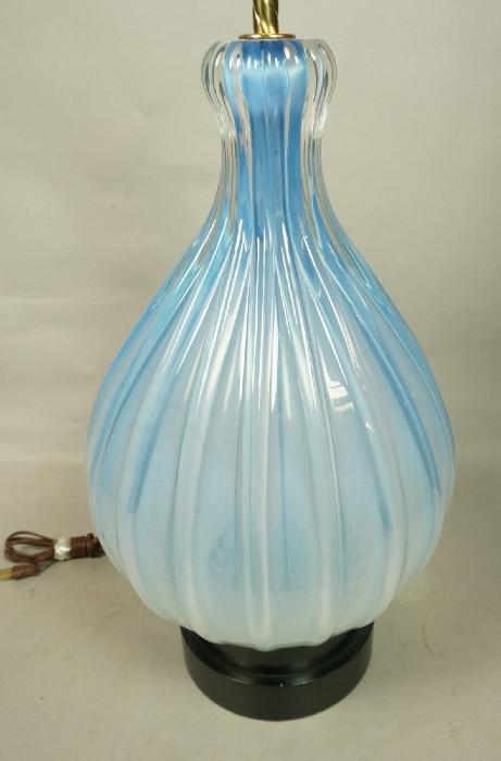 Lot 134  -  Large Murano Glass Table Lamp.  Opaline ribbed glass.  Blue.  Black metal base.-- Dimensions:  H: 33.5 inches: W: 12 inches --- 
