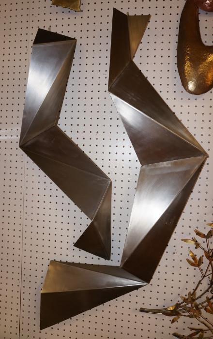 Lot 144  -  2pc C JERE Stainless Faceted Wall Sculpture. Folded origami style. Signed C JERE & Dated 2007. Labeled Designed in California, Made in China. Artisan House sticker. -- Dimensions:  H: 43 inches: W: 26 inches --- 