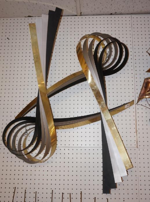 Lot 149  -  C JERE Ribbon Wall Sculpture. Black, Gold & Silver Metal Ribbons. Signed & dated 91.-- Dimensions:   --- 