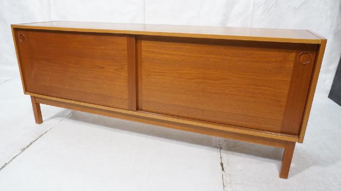 Lot 168  -  Danish Modern Teak Credenza Sideboard. Sliding door cabinet on wood legs. Recessed wood pulls. -- Dimensions:  H: 29.75 inches: D: 18.75 inches: L: 72.5 inches --- 