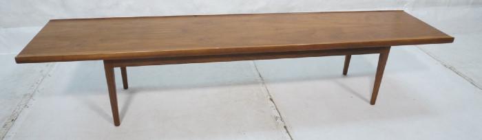Lot 173  -  American Modern Coffee Cocktail Table. Bench Table by DREXEL. Tapered legs. Raised edge table top.-- Dimensions:  H: 15.25 inches: D: 16 inches: L: 75 inches --- 