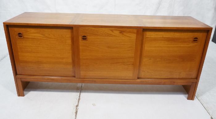 Lot 174  -  Danish Modern Teak Credenza Sideboard. Three sliding doors. Recessed wood pulls. -- Dimensions:  H: 30.25 inches: D: 18.5 inches: L: 71 inches --- 