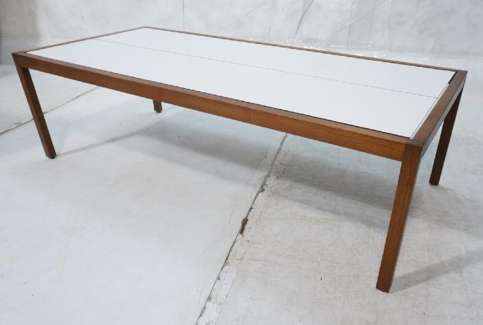 Lot 186  -  KNOLL White Laminate Top Long Coffee Table. Walnut frame with inset laminate cocktail table. KNOLL Label.-- Dimensions:  H: 16 inches: W: 54 inches: D: 24 inches --- 