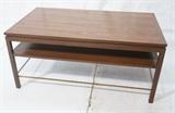 Lot 191  -  DUNBAR Walnut Banded Coffee Table. Two tier cocktail table. Brass stretchers. Metal Dunbar tag-- Dimensions:  H: 22 inches: W: 48 inches: D: 28 inches --- 