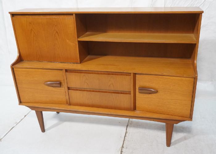 Lot 200  -  Danish Teak Desk Cabinet Shelve Unit. Drop down desk. Two drawers. Two doors. Open shelves.  Raised on legs. .-- Dimensions:  H: 48 inches: D: 17.5 inches: L: 65.75 inches --- 