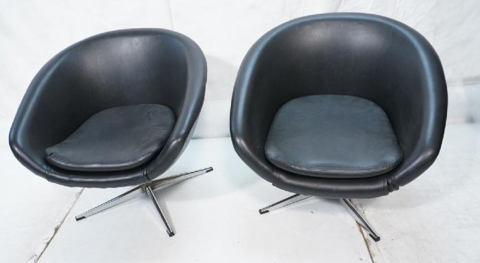Lot 204  -  Pr OVERMAN Black Vinyl Swivel Lounge Chairs. Sweden. Chrome pedestal bases. Overman label. -- Dimensions:  H: 38 inches: W: 25 inches: D: 26 inches --- 