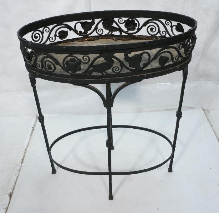 Lot 235  -  Vintage Iron Oval Planter Stand. Decorative Ironwork. Four leg base. Painted black-- Dimensions:  H: 33 inches: W: 26 inches: D: 15 inches --- 