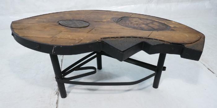Lot 238  -  HARRY BALMER style Industrial Wood Plank Coffee Table. Wood planks in Iron Frame. Two swing out metal compartments. One inset decorative panel. One area with carved oval relief. On heavy iron base. Not marked.-- Dimensions:  H: 19 inches: W: 45 inches: D: 23 inches --- 